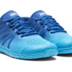 A pair of bright blue barefoot athletic shoes with a mesh design and textured soles offers comfort for digital nomads on the move. With blue laces and 'XERO' on the tongue, these shoes sit against a plain white background.
